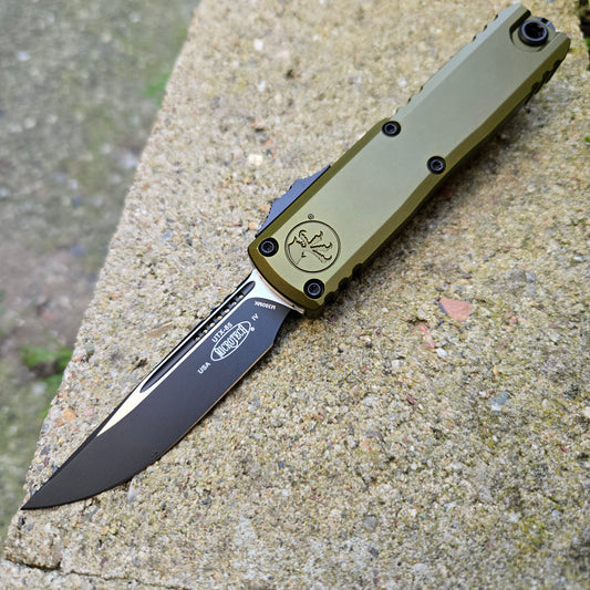 Folding knife with a visible brand logo on a concrete surface